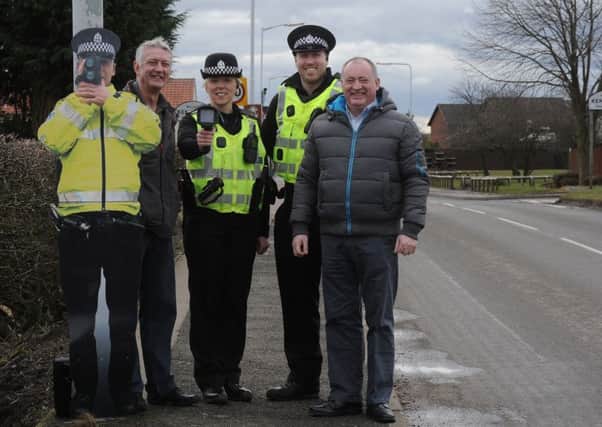 Constables Lorraine King and Gordon Latto and councillors Tom Adams and Charles Haffey with one of the cardboard cutout cops in Levenmouth in Fife.