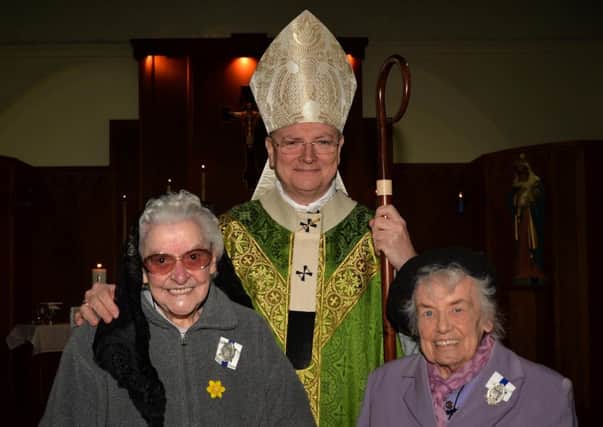 Archbishop Leo Cushley with Mrs Annie DAgrosa and Miss Sybil
McCabe, with their diocease medals,