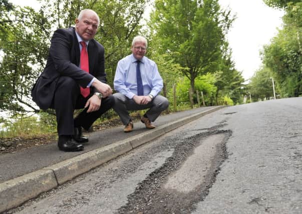 Councillor's Watson McAteer and Stuart Marshall in Wilton Park Road with pothole problems.