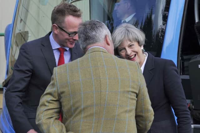 MP John Lamont, left, with Theresa May last year in Kelso, one of only three Borders towns expected to retain their RBS branches.