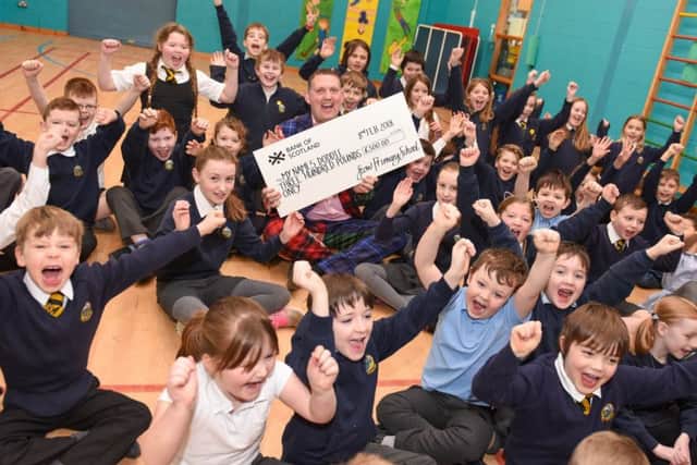 Doddie Weir at Stow Primary School collecting a cheque for money raised for the My Name'5 Doddie Foundation.