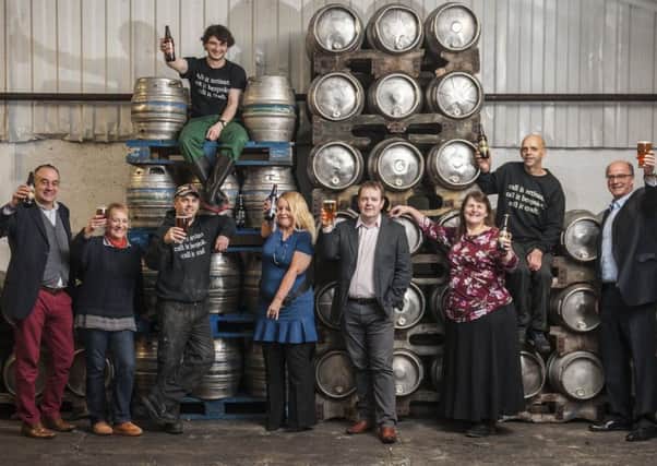 Broughton Ales bosses Steve McCarney, far left, John Hunt, far right, and David McGowan, sixth from left, with staff.