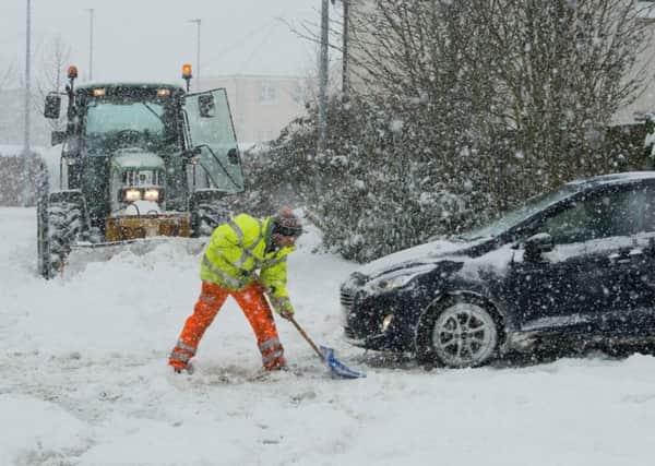 Council workmen try to clear the deep snow from the roads in Lauder