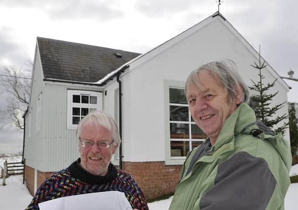 Midlem Village Hall's Lawrence Robertson (left) and Tony Clay study  plans for the hall development back in 2014.