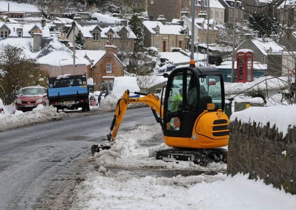Snow being cleared away in Selkirk's Yarrow Terrace on Friday.