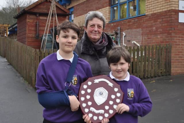 Sheena Chappell presents Melrose Primary pupils Elliot Etherington and Kai Waddell with the Jon Chappell Memorial Shield.