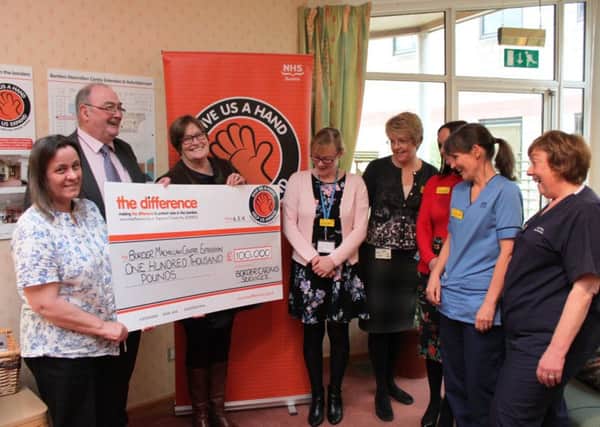 From left: Wendy McMillan, Jim Thomson and Val McNab of Border Caring Services, get the desired reaction from the Borders Macmillan Centres Amanda Fiddes, Verna Henderson, Rachel Johnson, Lesley Flannigan and Judith Smith as the giant cheque is revealed.