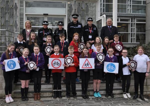 Pupils from eight of the 10 winning schools with police officers, council officer Karen McGrath, back far left, and councillor Gordon Edgar, back far right.
