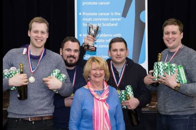 Big Quiz winners Marc Playfair, Rory Hedderley, Bruce Hunter and Lewis Playfair with Lucille Paterson, Dunc's widow, at the Big Quiz on Friday night.