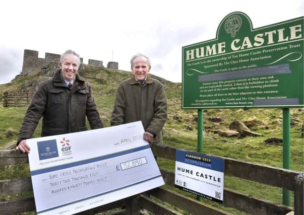 Fallago Environment Fund chairman Gareth Baird, left, giving Â£32,890 to the Hume Castle Preservation Trusts Douglas Tweedie.
