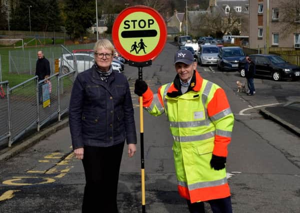 Hawick and Denholm councillor Clair Ramage with Billy O'Neill, a lollipop man at the town's Wilton Primary School.