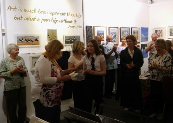 Exhibition opening...Rotary vice-president Ruth Collin presenting a young artist award to Lucy Reid in 2017.
