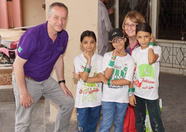 Karachi trip...in 2016 was an eye-opener for Peter Croan and Tricia Paterson, pictured here with some local children during their  visit.