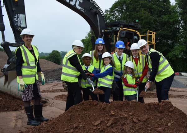 Councillor Carol Hamilton supervises as council leader Shona Haslam and deputy first minister John Swinney help pupils Sana Saukawa (Howdenburn), Kira Renilson (Jed Grammar)  Alice Hickson (Howdenburn), Harry Brown (Jed Grammar) and Ella McGovern and Ellie Scott (both Parkside) get the earth moving on the new campus on Monday afternoon.