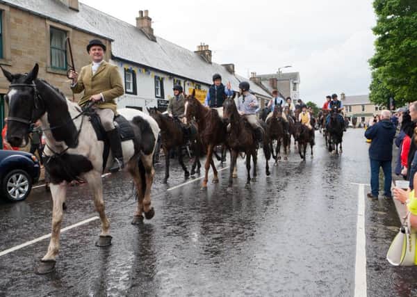 Acting Father John Lyle helps lead the cavalcade into Denholm.