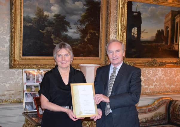 Helen Currie is rewarded for her 25 years' service at Bowhill by the Duke of Buccleuch.