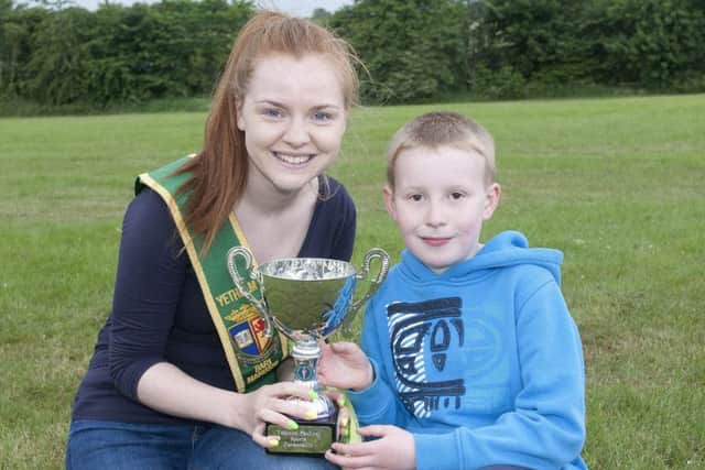 Bari Manushi Natasha Gray presents the cup for best boy to Max Lee at the sports at Yetholm.