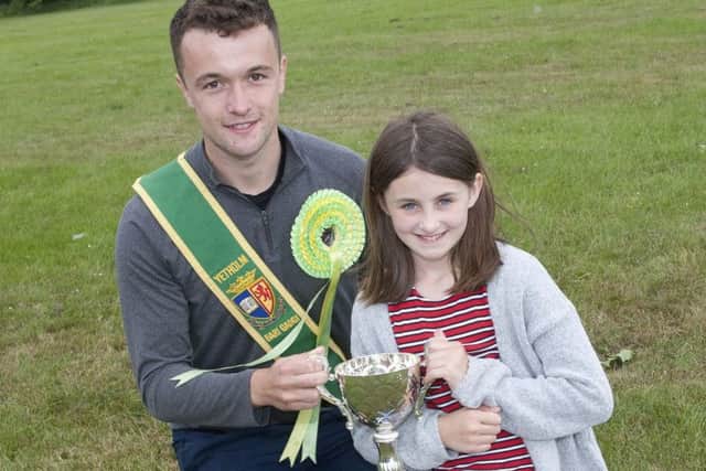Bari Gadgi Tom Grindell presents the cup for best girl at Yetholm sports to Caitlin Butler.