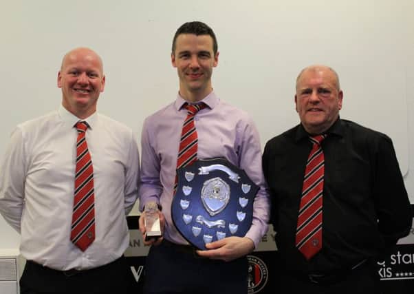 Departing manager Steven Noble, centre, receives his accolades.