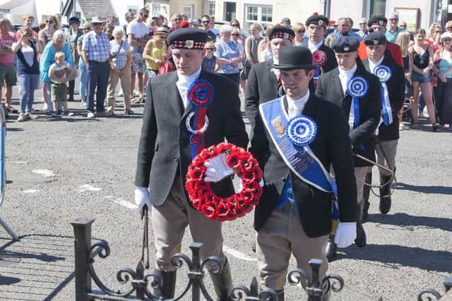 Jethart Callant Nick Arnold and Kelso Laddie Sean Hook lay a wreath at Morebattle's war memorial on Sunday.