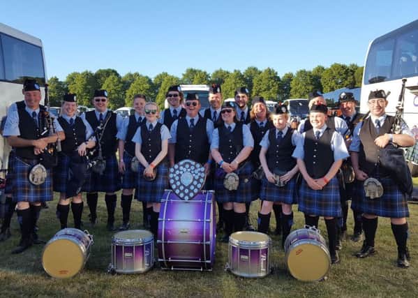 Tweedvale Pipe Band post with their champions silverware on Saturday.