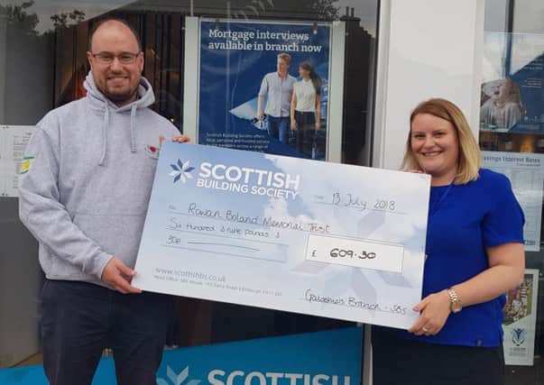 Kenny Paterson from the Rowan Boland Memorial Trust receives a cheque for Â£609 from Claire Swanson of the Scottish Building Society's Galashiels branch