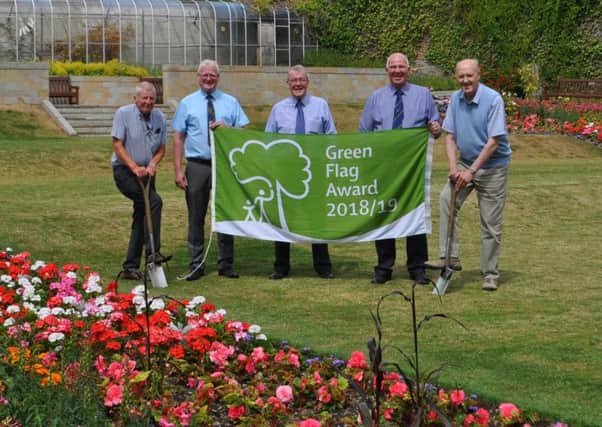 From left, Alex Bell of Hawick in Bloom, councillors Stuart Marshall, George Turnbull and Watson McAteer and Jake Coltman of Hawick in Bloom in the town's Wilton Lodge Park celebrating as it claims Green Flag status.