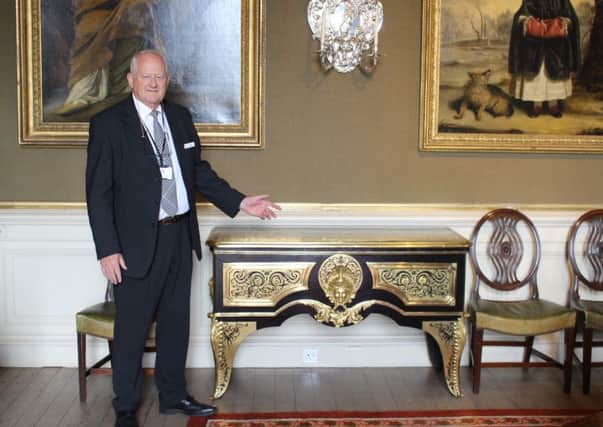 Bowhill House tour guide Adam Borwick with the Boulle commode