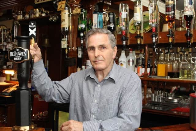 Ian Niblo behind the bar.