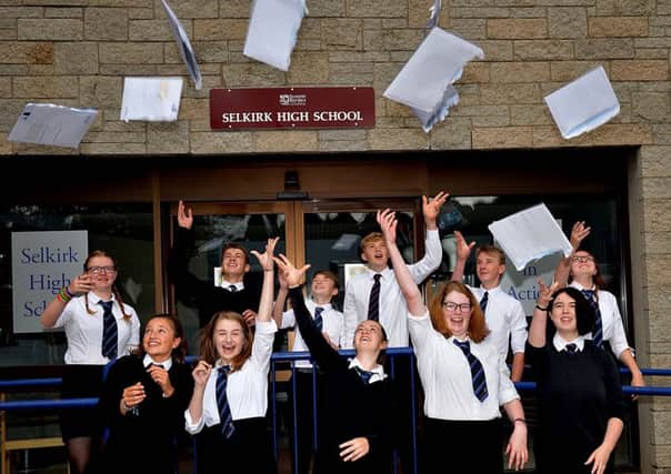 Pupils at Selkirk High School open their exam results.