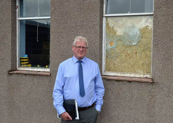 Councillor Stuart Marshall surveys some of the damage to Burnfoot Community School.