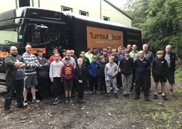 Borders Boys' Brigade 2018 campers with the lorry loaned by heating engineers Turnbull & Scott to transport their equipment.