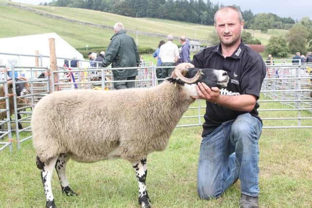 Scott Anderson with his champion black face ewe.