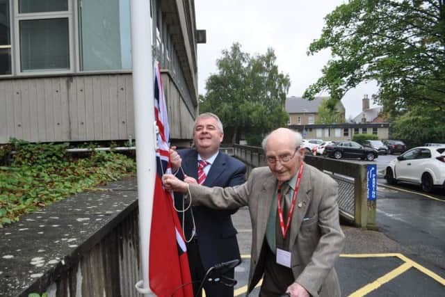 Stephen helps David Parker raise the Red Ensign