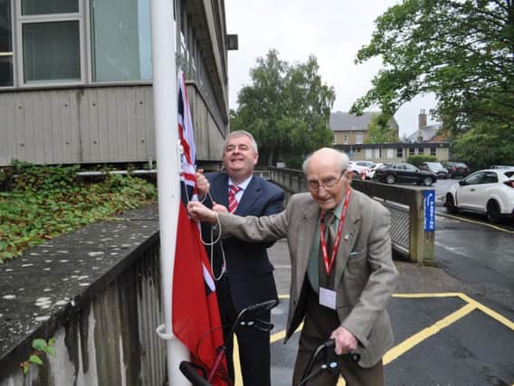 Stephen helps David Parker raise the Red Ensign