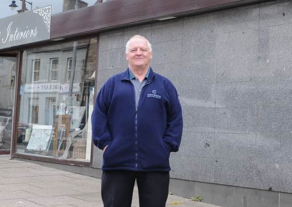 Colin Graham stands outside the former RBS building in Selkirk.