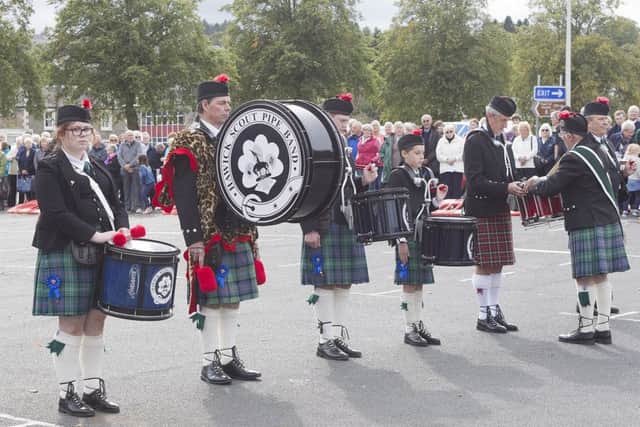 Drummers line up to deliver their drums to be made into an alter.