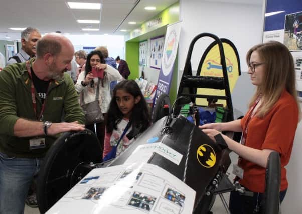 Pictured are college staff members Dave Black and Lauren Hamilton demonstrating the Greenpower electric racing car at the Diversity Celebration and Exhibition at Borders College.