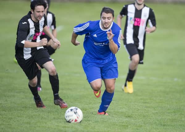 Dawid Lyko on the attack for Hawick Royal Albert, in blue.