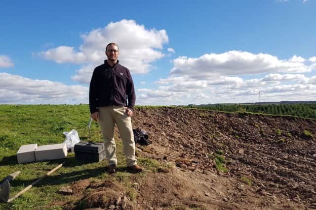 Scottish Borders Council archaeologist, Dr Chris Bowles, with some of the boxed remains at the site in Lilliesleaf