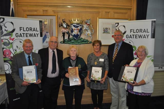 Representatives from Hawick, Westruther, Coldstream and Coldingham pick up their awards from Councillor Sandy Aitchison and Sandy Mcvitie, one of the judges.