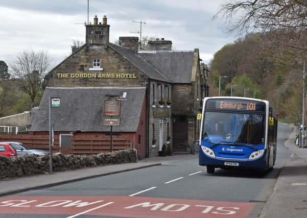 The number 101 Stagecoach bus heading east through West Linton.