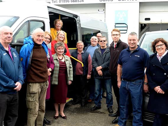 Christine Grahame and Christina McKelvie (inside the bus) are joined by volunteer drivers and funding partners of the scheme.