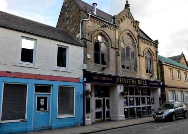 The Hunters Hall in Galashiels and the old butcher's shop on its left.
