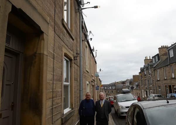 Councillor Davie Paterson with Jim Matthews, a resident concerned about the new street lights in Gladstone Street, Hawick, being left on all day.
