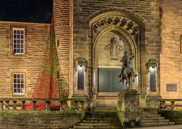 Galashiels' war memorial, with the cascade of plastic poppies.