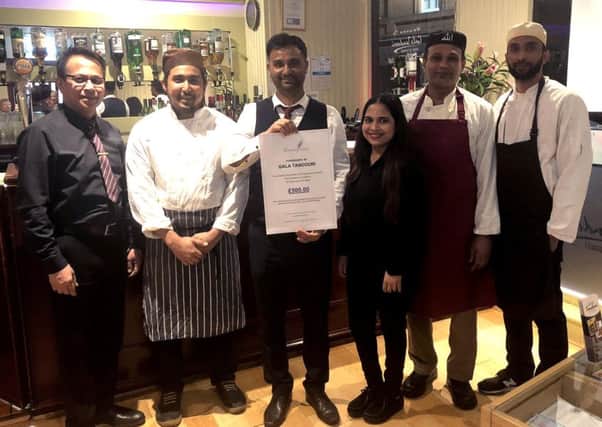 Amir Hossain and his staff at Gala Tandoori held a fundraising night for The Lavender Touch charity. He donated his profits during the course of the evening to the charity. Photo shows Amir and the staff donating Â£500 to the charity.