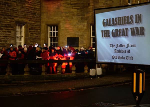 Galashiels Remembers' 'Angels Wings' ceremony on Sunday evening. Compered by Alisdair Hutton and featuring music from the town band, pipe band and Langlee Choir. The photos of the world war one dead were beamed up on a big screen beside the memorial.