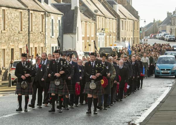 Pipers Euan Craig, Jake Mirley and Callum Atkinson lead the remembrance parade. The route is lined with knitted poppies planted by Lauder in Bloom.