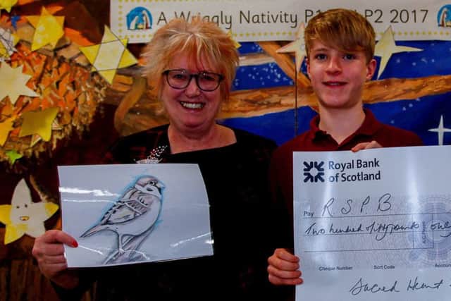 MSP Christine Grahame with 2017 Christmas competition winner Rory Scott at Sacred Heart Primary School in Penicuik.